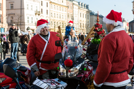 CRACOW, POLAND - DECEMBER 6, 2015: the parade of Santa Clauses on motorcycles around the Main Market Square in Cracow. Polandのeditorial素材