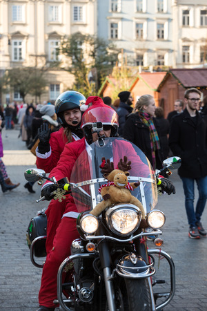 CRACOW, POLAND - DECEMBER 6, 2015: the parade of Santa Clauses on motorcycles around the Main Market Square in Cracow. Polandのeditorial素材