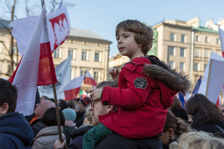 CRACOW, POLAND - DECEMBER 19, 2015: Cracow, Main Square -  The demonstration of the Committee of the Defence Protection of the Democracy against the break of law through the government PIS in Poland.のeditorial素材