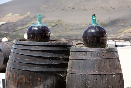 Barrels and  big bottles with grape wine - malvasia.  Lanzarote, Spainのeditorial素材