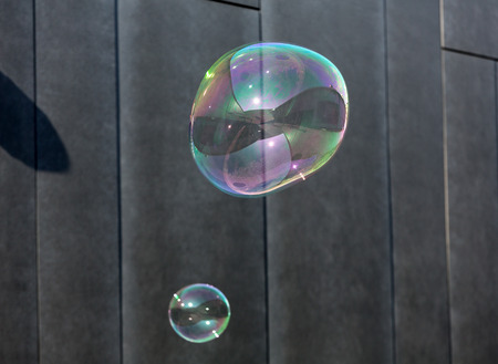 The transparent, iridescent soap bubbles  on black backgroundの写真素材