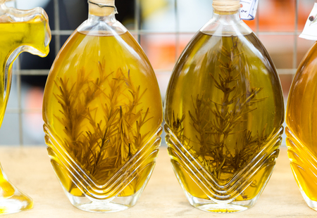 ROME, ITALY - JUNE 15, 2015: Rome - Campo dei Fiori. Shopboard with bottles puring virgin olive oil with  rosemaryのeditorial素材