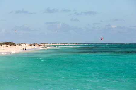 kitesurfers surfing on a flat azure water of Atlantic ocean in Corralejo. Fuertevetnura, Spainの写真素材