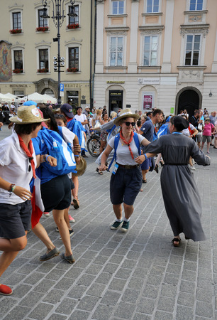 CRACOW, POLAND - JULY 24, 2016: Pilgrims of World Youth Day sing and dance on the Main Square in  Cracow. Polandのeditorial素材