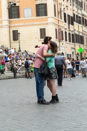 ROME, ITALY - JUNE 15, 2015: Attractive young couple kissing in Piazza Spagna during their vacation inRome. Italyのeditorial素材