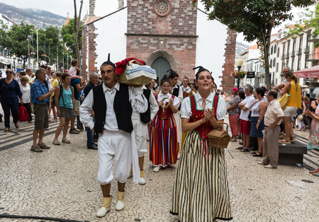 FUNCHAL, PORTUGAL - SEPTEMBER 2, 2015: Dancers with local costumes demonstrating a folk dance during the Wine Festival in Funchal on the Madeira, Portugal.のeditorial素材
