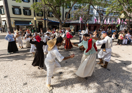 FUNCHAL, PORTUGAL - SEPTEMBER 1, 2015: Dancers with local costumes demonstrating a folk dance during the Wine Festival in Funchal on the Madeira, Portugal.のeditorial素材