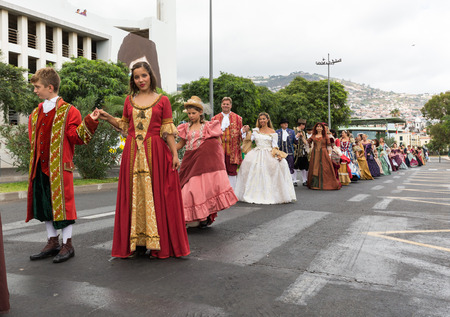 FUNCHAL, MADEIRA, PORTUGAL - SEPTEMBER 4, 2016: Group of people in historical fashion dress durnig historical and ethnographic  parade of Madeira Wine Festival in Funchal. Madeira, Portugalのeditorial素材