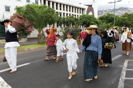 FUNCHAL, MADEIRA, PORTUGAL - SEPTEMBER 4, 2016: Group of people in traditional costume durnig historical and ethnographic  parade of Madeira Wine Festival in Funchal.のeditorial素材