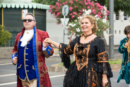 FUNCHAL, MADEIRA, PORTUGAL - SEPTEMBER 4, 2016:  Group of people in historical fashion dress durnig historical and ethnographic  parade of Madeira Wine Festival in Funchal. Madeira, Portugalのeditorial素材