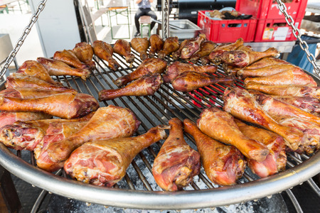 BBQ turkey legs on a large grill.の写真素材