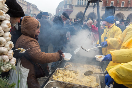 CRACOW, POLAND - DECEMBER 18, 2016:  Christmas Eve for poor and homeless on the Central Market in Cracow. Every year the group Kosciuszko prepares the greatest eve in the open air in Polandのeditorial素材