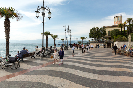 LAZISE. ITALY - April 30, 2016: People on Promenade of Lazise at  Garda Lake, Italyのeditorial素材