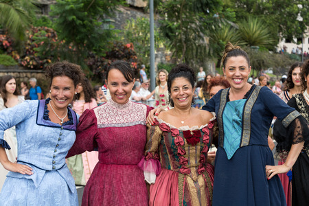 FUNCHAL, MADEIRA, PORTUGAL - SEPTEMBER 4, 2016:  Group of women in historical fashion dress durnig historical and ethnographic  parade of Madeira Wine Festival in Funchal. Madeira, Portugalのeditorial素材