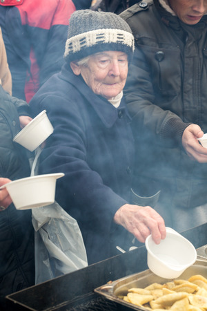 CRACOW, POLAND - DECEMBER 18, 2016:  Christmas Eve for poor and homeless on the Central Market in Cracow. Every year the group Kosciuszko prepares the greatest eve in the open air in Polandのeditorial素材