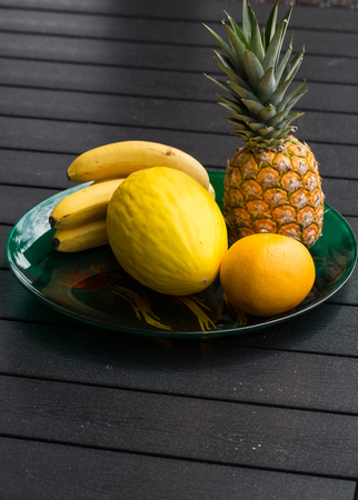 Assortment of fresh exotic fruits on  black table