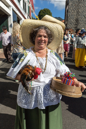 ESTREITO DE CAMARA DE LOBOS, PORTUGAL - SEPTEMBER 10, 2016: Woman wearing in traditional costume at Madeira Wine Festival in Estreito de Camara de Lobos, Madeira, Portugal. The Madeira Wine Festival honors the grape harvest with a celebration of traditionのeditorial素材