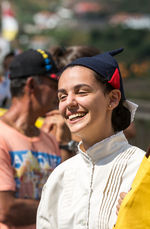 ESTREITO DE CAMARA DE LOBOS, PORTUGAL - SEPTEMBER 10, 2016: Woman wearing in traditional costume at Madeira Wine Festival in Estreito de Camara de Lobos, Madeira, Portugal. The Madeira Wine Festival honors the grape harvest with a celebration of traditionのeditorial素材