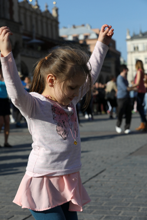CRACOW, POLAND - APRIL 1, 2017: International Flashmob Day of Rueda de Casino, 57 countries, 160 cities. Several hundred persons dance Hispanic rhythms on the Main Square in Cracow. Polandのeditorial素材