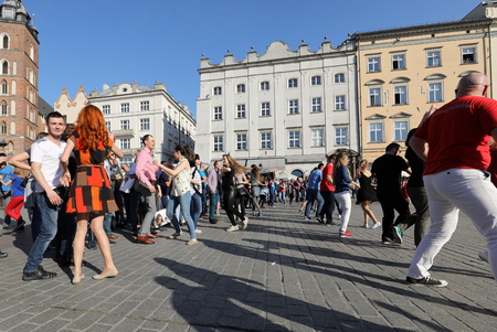CRACOW, POLAND - APRIL 2, 2016: International Flashmob Day of Rueda de Casino, 57 countries, 160 cities. Several hundred persons dance Hispanic rhythms on the Main Square in Cracow. Polandのeditorial素材