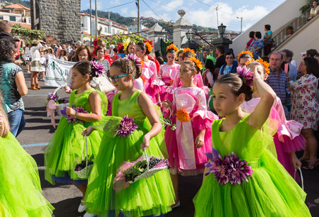 ESTREITO DE CAMARA DE LOBOS, PORTUGAL - SEPTEMBER 10, 2016: Girls wearing in colorful costumes at Madeira Wine Festival in Estreito de Camara de Lobos, Madeira, Portugal. The Madeira Wine Festival honors the grape harvest with a celebration of traditionalのeditorial素材