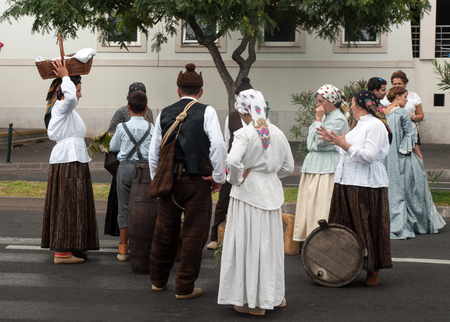 FUNCHAL, PORTUGAL - SEPTEMBER 4, 2016: Group of people in traditional costume  durnig historical and ethnographic  parade of Madeira Wine Festival in Funchal. Madeira, Portugalのeditorial素材