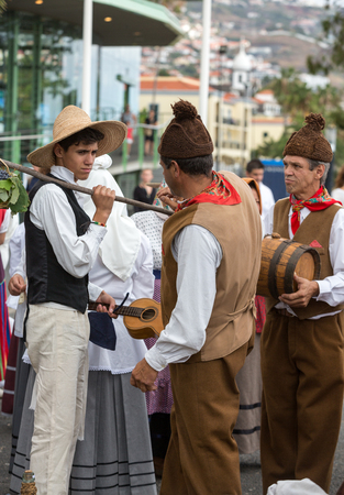 FUNCHAL, PORTUGAL - SEPTEMBER 4, 2016: Group of people in traditional costume  durnig historical and ethnographic  parade of Madeira Wine Festival in Funchal. Madeira, Portugalのeditorial素材