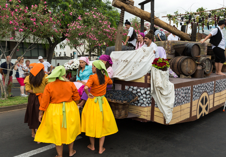 FUNCHAL, PORTUGAL - SEPTEMBER 4, 2016: Group of people in traditional costume  durnig historical and ethnographic  parade of Madeira Wine Festival in Funchal. Madeira, Portugalのeditorial素材