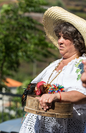 ESTREITO DE CAMARA DE LOBOS, PORTUGAL - SEPTEMBER 10, 2016: Women wearing in traditional costumes at Madeira Wine Festival in Estreito de Camara de Lobos, Madeira, Portugal. The Madeira Wine Festival honors the grape harvest with a celebration of traditioのeditorial素材