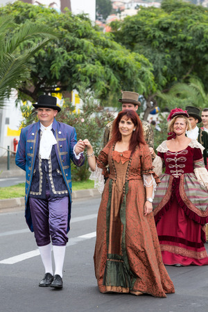 FUNCHAL, MADEIRA, PORTUGAL - SEPTEMBER 4, 2016:  Group of people in historical fashion dress durnig historical and ethnographic  parade of Madeira Wine Festival in Funchal. Madeira, Portugalのeditorial素材