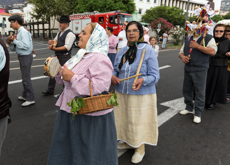 FUNCHAL, MADEIRA, PORTUGAL - SEPTEMBER 4, 2016:  Group of people in traditional costume durnig parade of Madeira Wine Festival in Funchal.Madeira, Portugalのeditorial素材