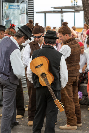 FUNCHAL, PORTUGAL - SEPTEMBER 4, 2016: Group of people in traditional costume  durnig historical and ethnographic  parade of Madeira Wine Festival in Funchal. Madeira, Portugallのeditorial素材