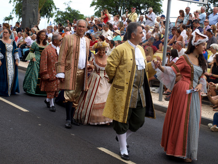 FUNCHAL, MADEIRA, PORTUGAL - SEPTEMBER 4, 2016:  Group of people in historical fashion dress durnig historical and ethnographic  parade of Madeira Wine Festival in Funchal. Madeira, Portugalのeditorial素材