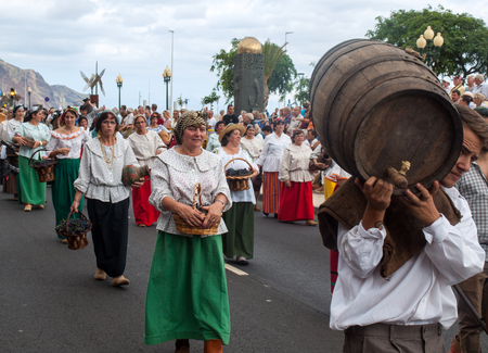 FUNCHAL, PORTUGAL - SEPTEMBER 4, 2016: Group of people in traditional costume  durnig historical and ethnographic  parade of Madeira Wine Festival in Funchal. Madeira, Portugallのeditorial素材