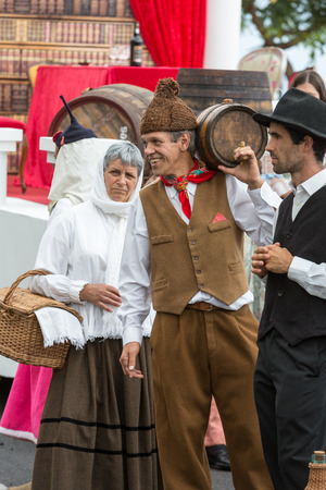 FUNCHAL, PORTUGAL - SEPTEMBER 4, 2016: Group of people in traditional costume  durnig historical and ethnographic  parade of Madeira Wine Festival in Funchal. Madeira, Portugallのeditorial素材