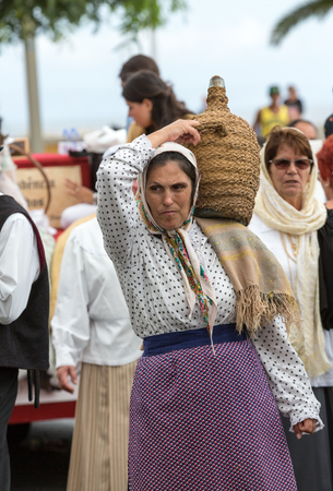 FUNCHAL, PORTUGAL - SEPTEMBER 4, 2016: Group of people in traditional costume  durnig historical and ethnographic  parade of Madeira Wine Festival in Funchal. Madeira, Portugallのeditorial素材