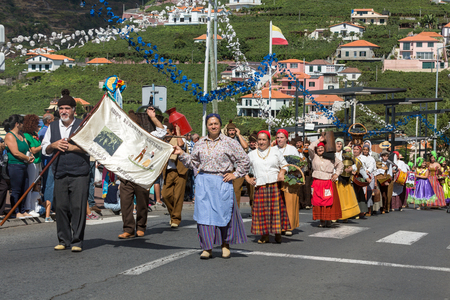 ESTREITO DE CAMARA DE LOBOS, PORTUGAL - SEPTEMBER 10, 2016: People wearing in traditional costumes at Madeira Wine Festival in Estreito de Camara de Lobos, Madeira, Portugal. The Madeira Wine Festival honors the grape harvest with a celebration of traditiのeditorial素材