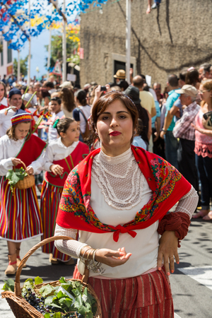 ESTREITO DE CAMARA DE LOBOS, PORTUGAL - SEPTEMBER 10, 2016: Girls wearing in traditional costumes at Madeira Wine Festival in Estreito de Camara de Lobos, Madeira, Portugal. The Madeira Wine Festival honors the grape harvest with a celebration of traditioのeditorial素材