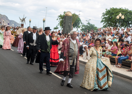 FUNCHAL, MADEIRA, PORTUGAL - SEPTEMBER 4, 2016:  Group of people in historical fashion dress durnig historical and ethnographic  parade of Madeira Wine Festival in Funchal. Madeira, Portugalのeditorial素材