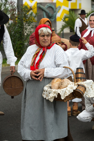 FUNCHAL, PORTUGAL - SEPTEMBER 4, 2016: Group of people in traditional costume  durnig historical and ethnographic  parade of Madeira Wine Festival in Funchal. Madeira, Portugallのeditorial素材
