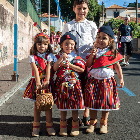 ESTREITO DE CAMARA DE LOBOS, PORTUGAL - SEPTEMBER 10, 2016: Children wearing in traditional costumes at Madeira Wine Festival in Estreito de Camara de Lobos, Madeira, Portugal.のeditorial素材