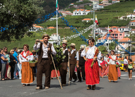 ESTREITO DE CAMARA DE LOBOS, PORTUGAL - SEPTEMBER 10, 2016: People wearing in traditional costumes at Madeira Wine Festival in Estreito de Camara de Lobos, Madeira, Portugal. The Madeira Wine Festival honors the grape harvest with a celebration of traditiのeditorial素材