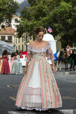 FUNCHAL, MADEIRA, PORTUGAL - SEPTEMBER 4, 2016:  Woman in historical fashion dress durnig historical and ethnographic  parade of Madeira Wine Festival in Funchal. Madeira, Portugalのeditorial素材