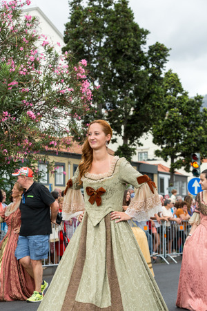 FUNCHAL, MADEIRA, PORTUGAL - SEPTEMBER 4, 2016:  Woman in historical fashion dress durnig historical and ethnographic  parade of Madeira Wine Festival in Funchal. Madeira, Portugalのeditorial素材
