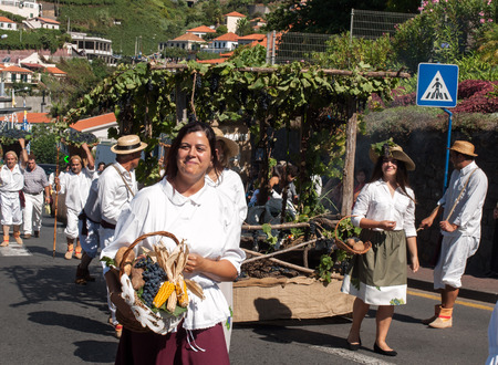 ESTREITO DE CAMARA DE LOBOS, PORTUGAL - SEPTEMBER 10, 2016: People wearing in traditional costumes at Madeira Wine Festival in Estreito de Camara de Lobos, Madeira, Portugal.のeditorial素材