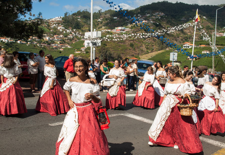 ESTREITO DE CAMARA DE LOBOS, PORTUGAL - SEPTEMBER 10, 2016: People wearing in traditional costumes at Madeira Wine Festival in Estreito de Camara de Lobos, Madeira, Portugal.のeditorial素材