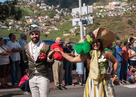 ESTREITO DE CAMARA DE LOBOS, PORTUGAL - SEPTEMBER 10, 2016: People wearing in traditional costumes at Madeira Wine Festival in Estreito de Camara de Lobos, Madeira, Portugal.のeditorial素材