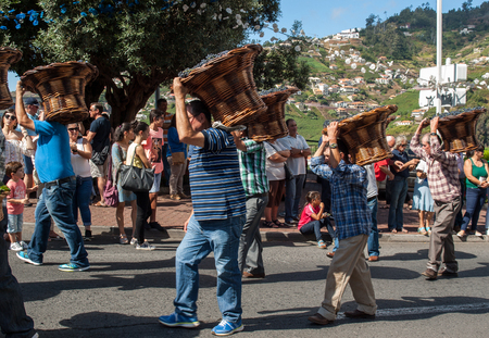 ESTREITO DE CAMARA DE LOBOS, PORTUGAL - SEPTEMBER 10, 2016: People wearing in traditional costumes at Madeira Wine Festival in Estreito de Camara de Lobos, Madeira, Portugal. The Madeira Wine Festival honors the grape harvest with a celebration of traditiのeditorial素材