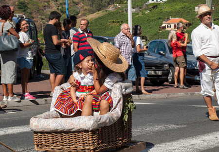 ESTREITO DE CAMARA DE LOBOS, PORTUGAL - SEPTEMBER 10, 2016: People wearing in traditional costumes at Madeira Wine Festival in Estreito de Camara de Lobos, Madeira, Portugal.のeditorial素材