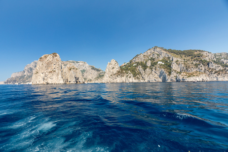 View from the boat on the cliff coast of Capri Island, Italyの写真素材